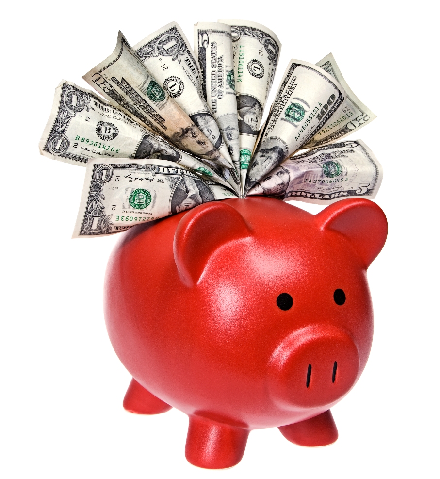 A piggy bank stuffed with cash isolated on a white background.